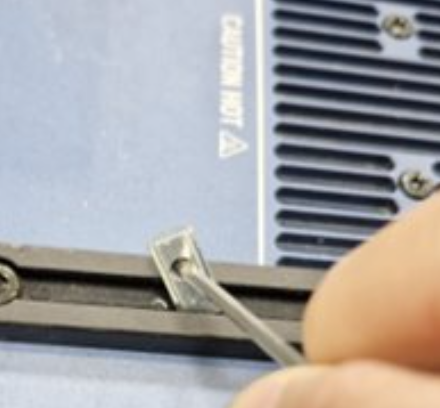 Remove spring nut from rail